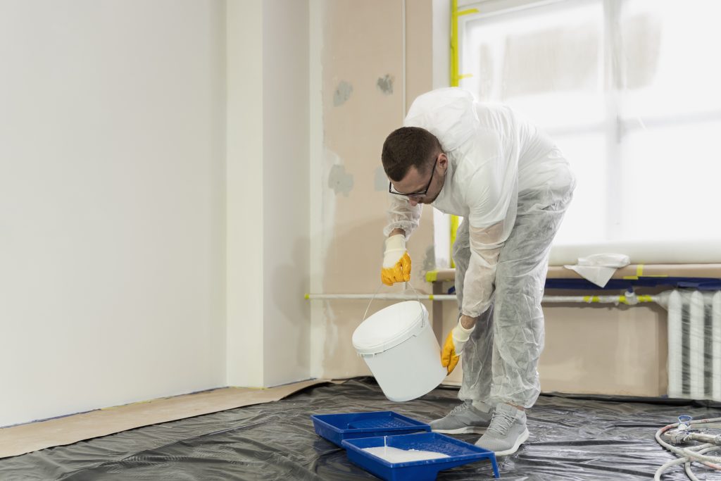 Close-up-of-a-technician-sealing-a-roof-with-waterproofing-membrane-highlighting-the-importance-of-roof-maintenance