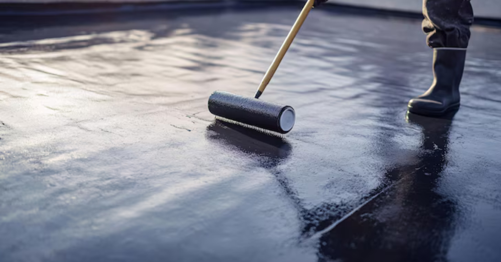 Individual-using-a-roller-to-paint-a-roof-demonstrating-waterproofing-services-for-enhanced-protection